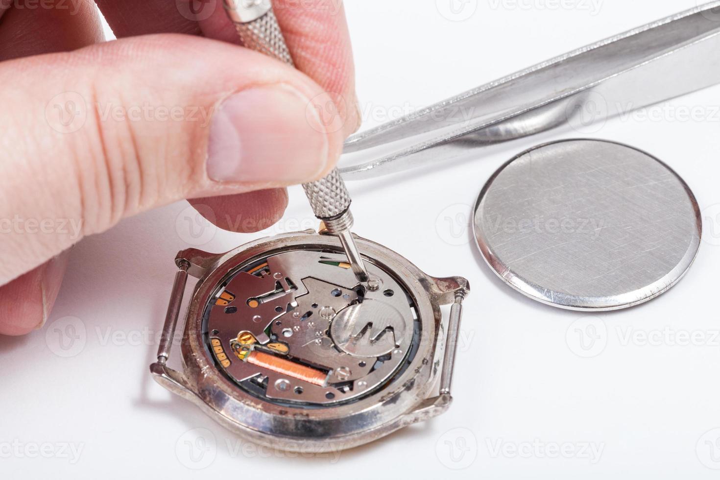 horologist replaces battery in quartz watch photo