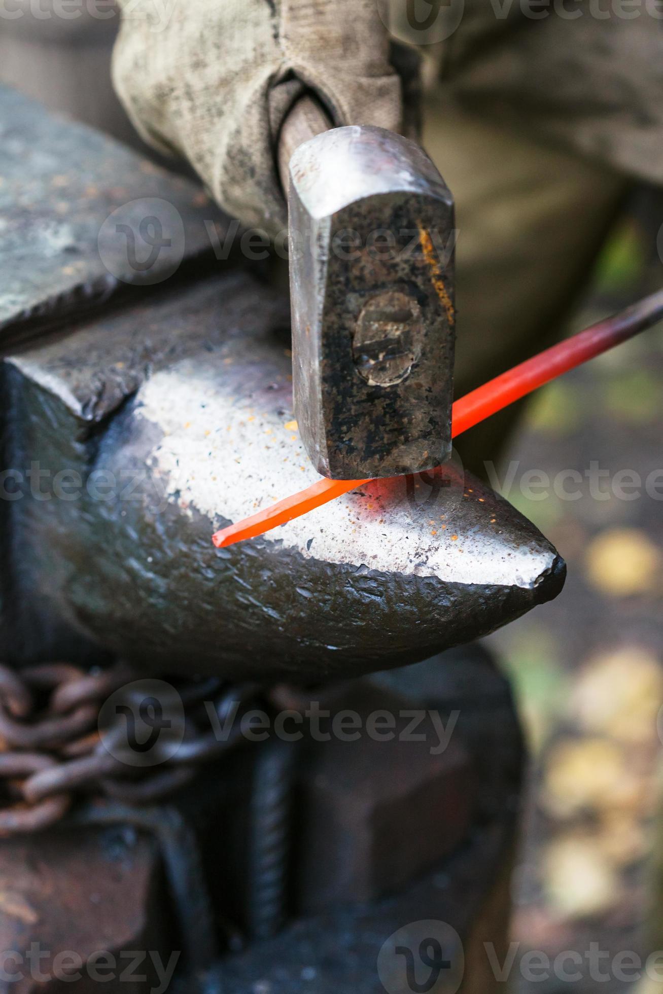 Blacksmith red hot steel rod on anvil 12251079 Stock Photo at