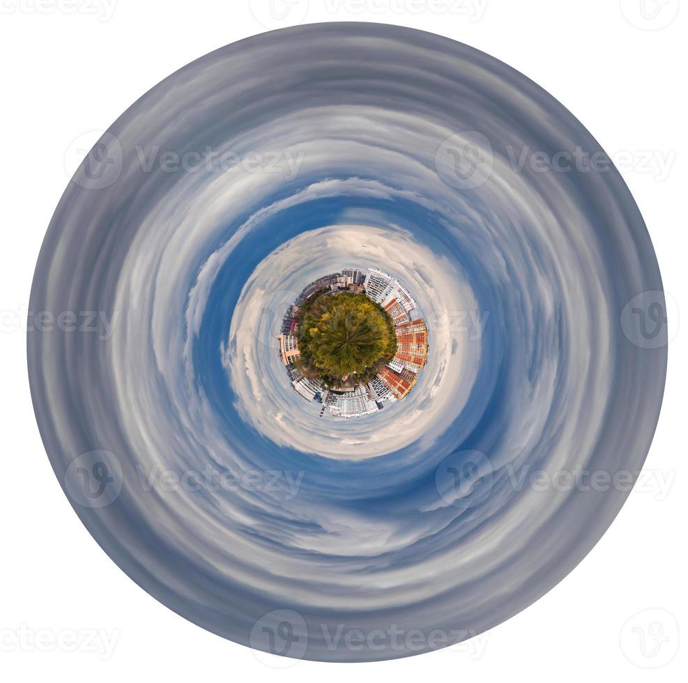 planet with forest and hoses in grey autumn clouds photo