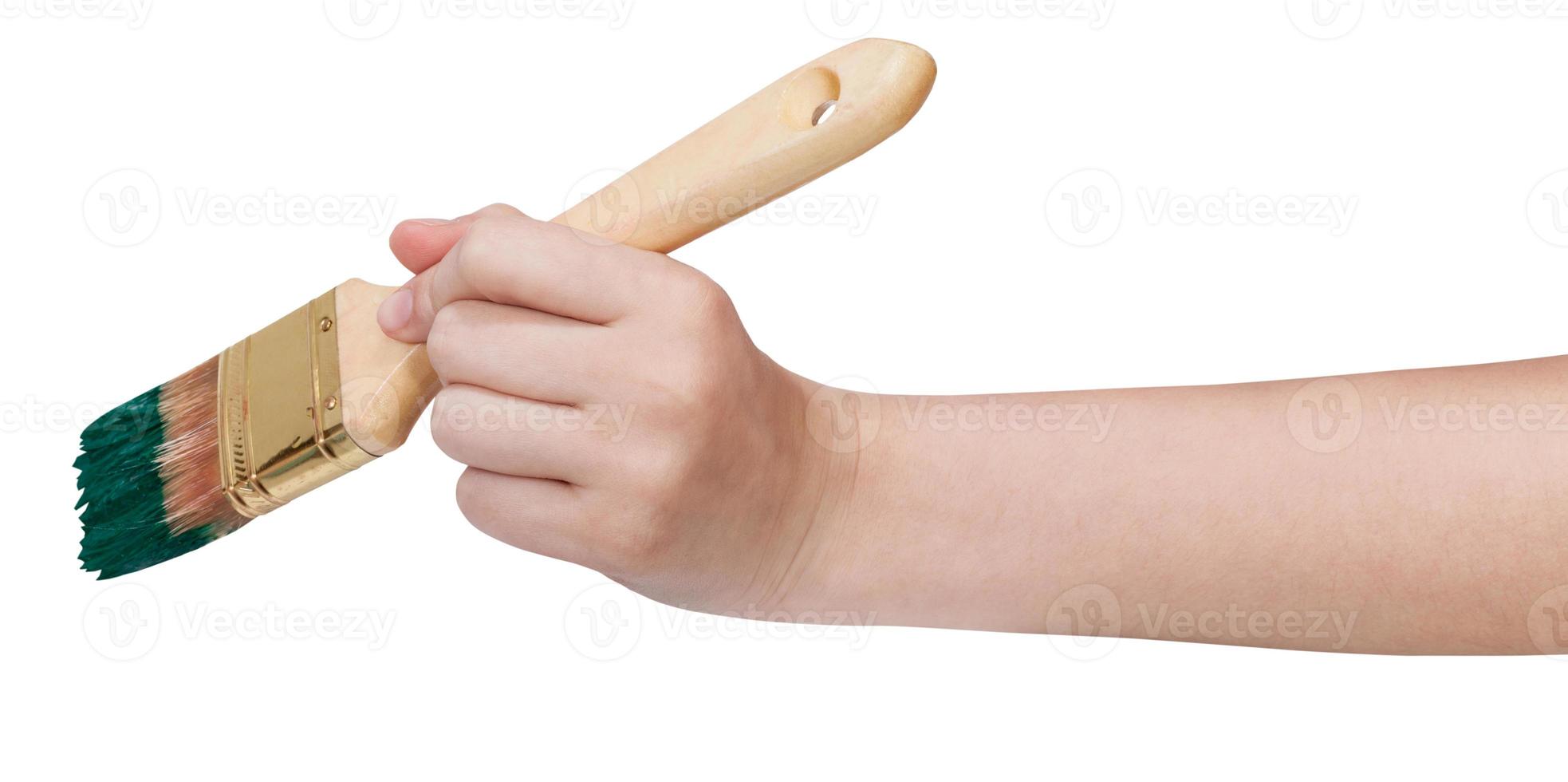 painter hand holds brush with green paint photo