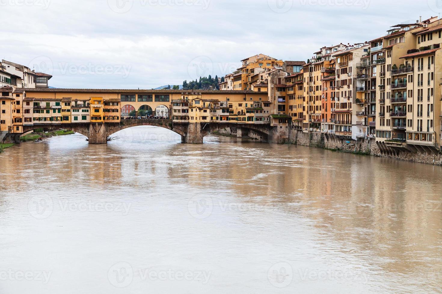 Ponte Vecchio over Arno River and houses in autumn photo