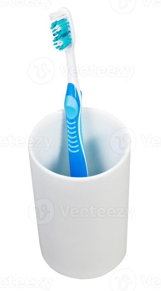 one blue tooth brush in ceramic glass photo