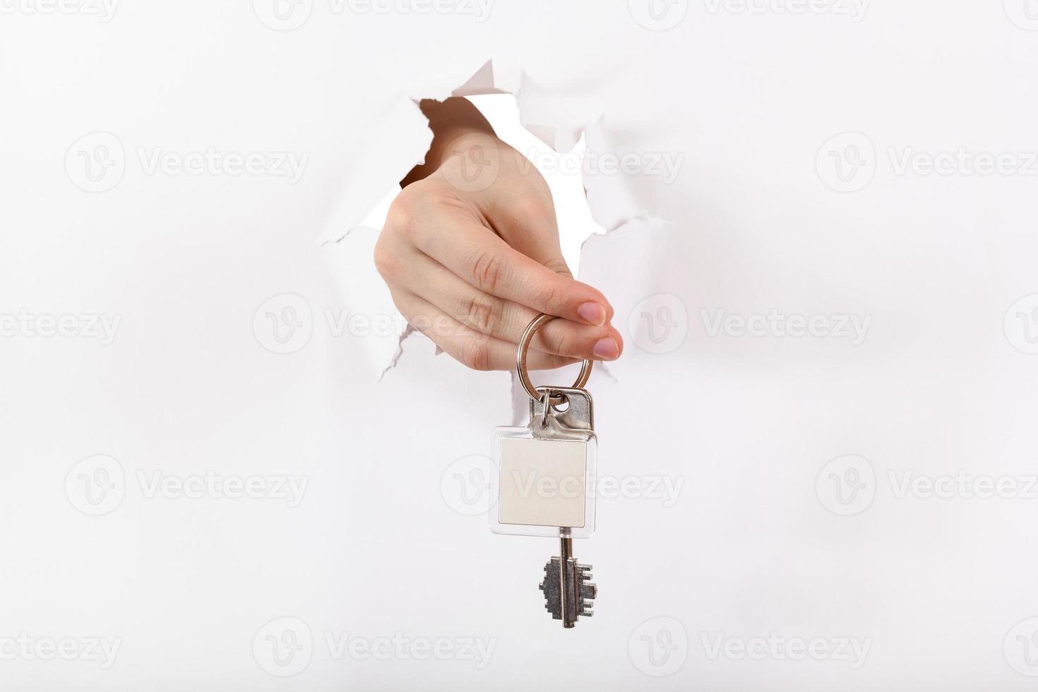 hand holds the keyring through a hole photo