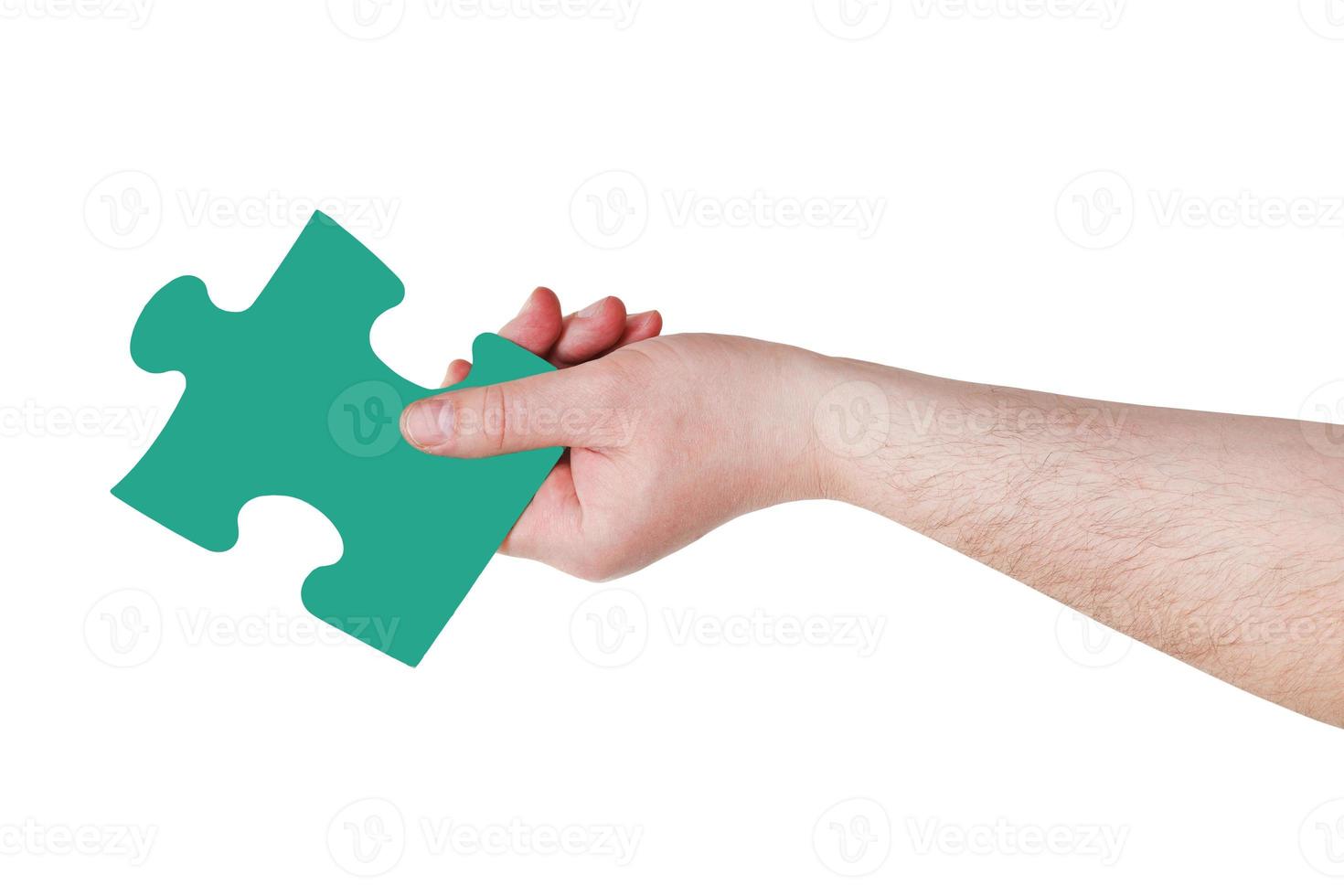 male hand with green puzzle piece photo