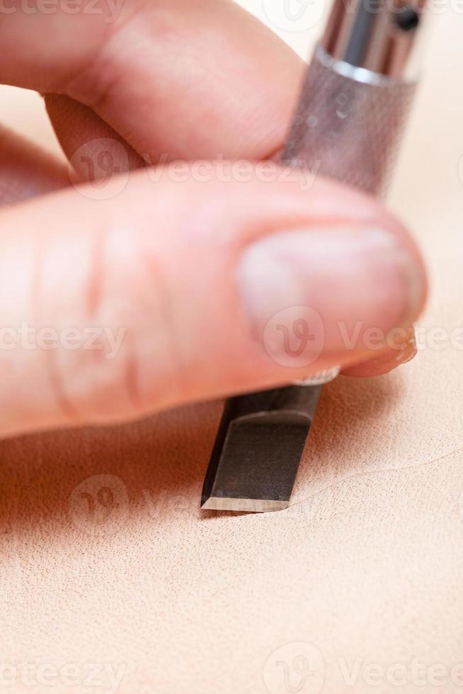 blade of swivel knife cut leather close up photo