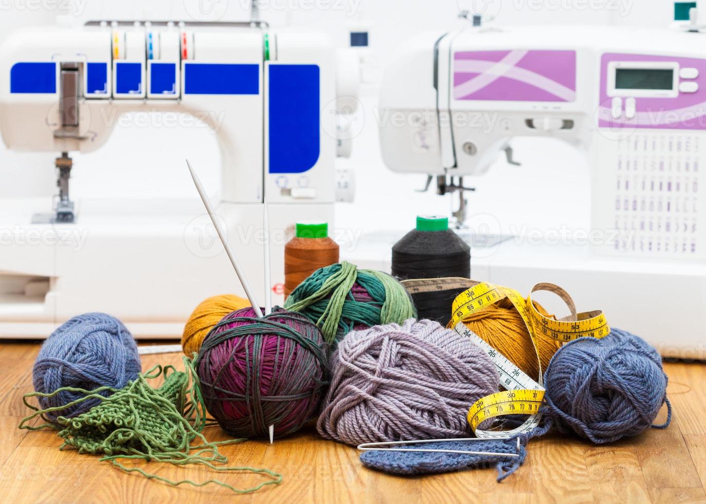 wool knitting yarn on table and sewing machines photo