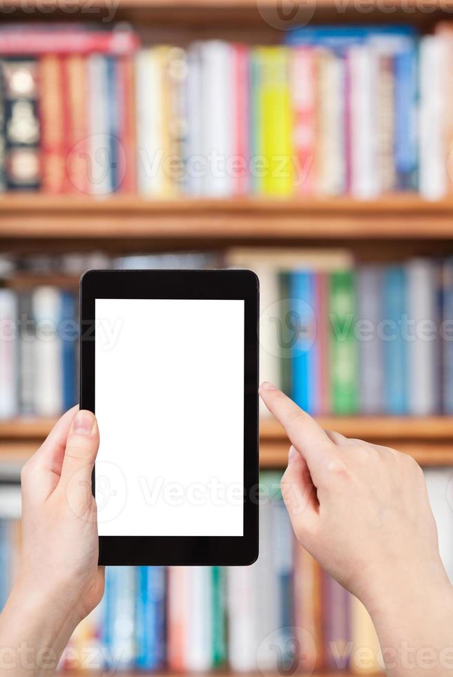 hand holds tablet pc and bookcase photo