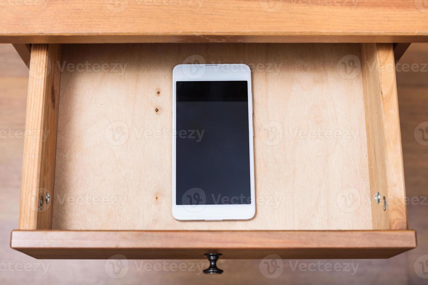 mobile phone in open drawer photo