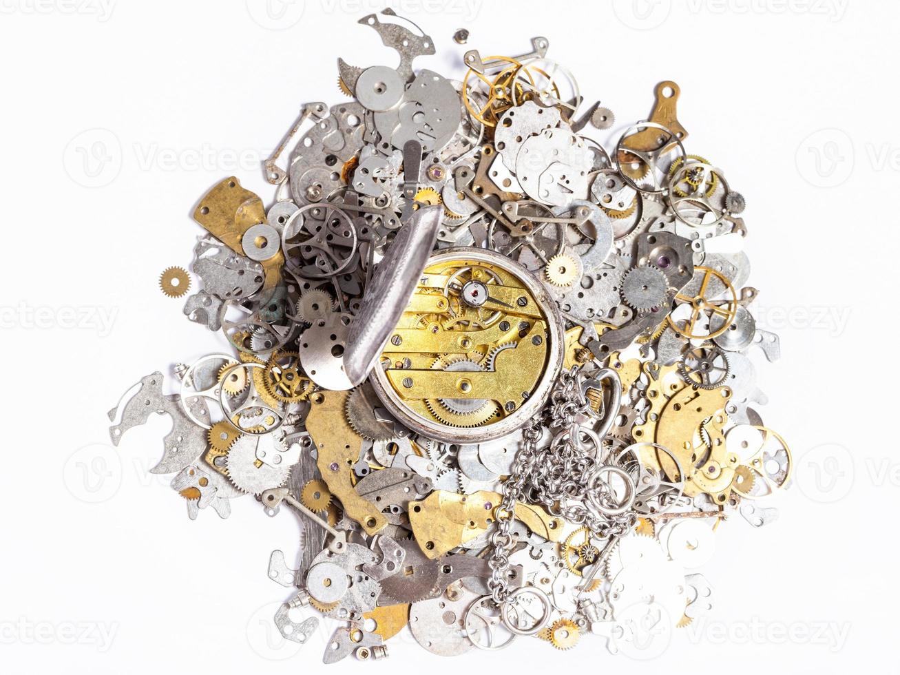 top view of pocket watch on pile of spare parts photo