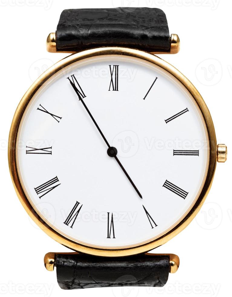 five minutes to five o'clock on dial of wristwatch photo