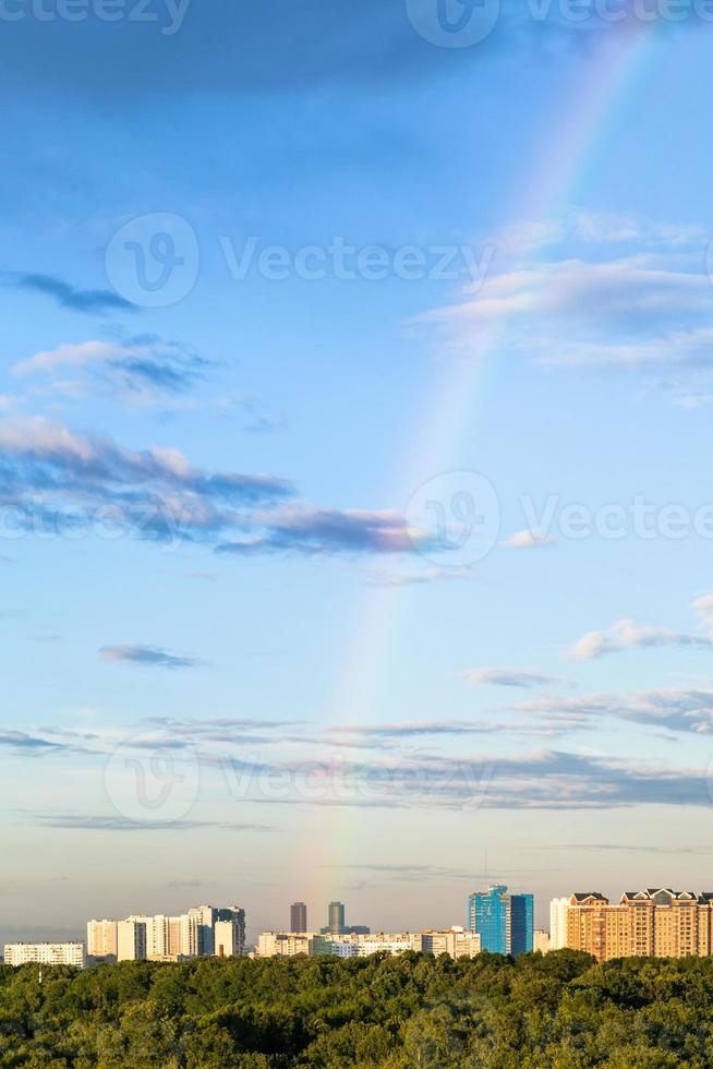 rainbow in evening sky over apartment buildings photo