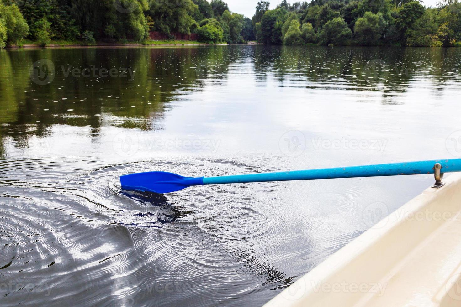 boating with oars in city pond in summer photo