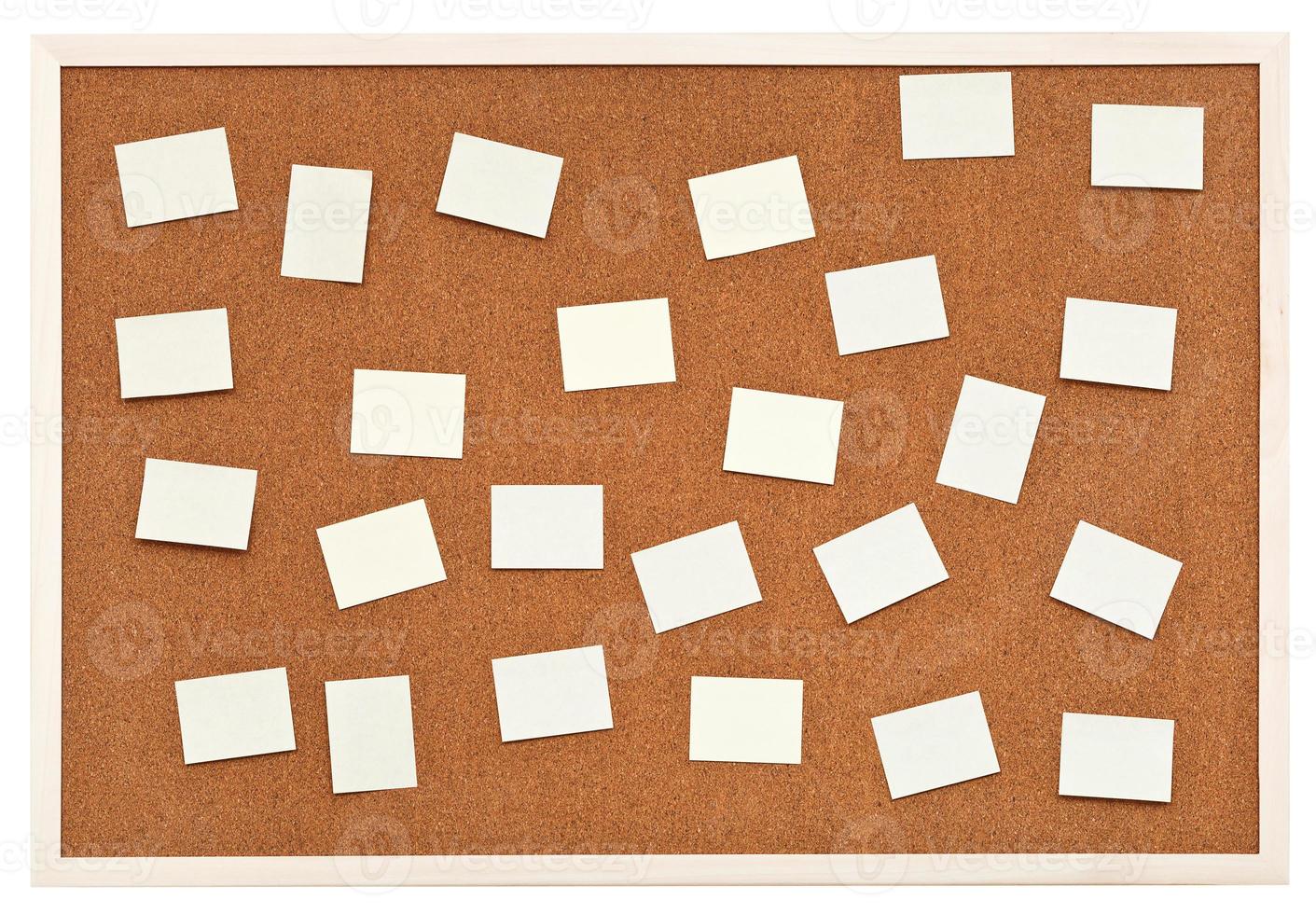 many small sheets of paper on bulletin cork board photo