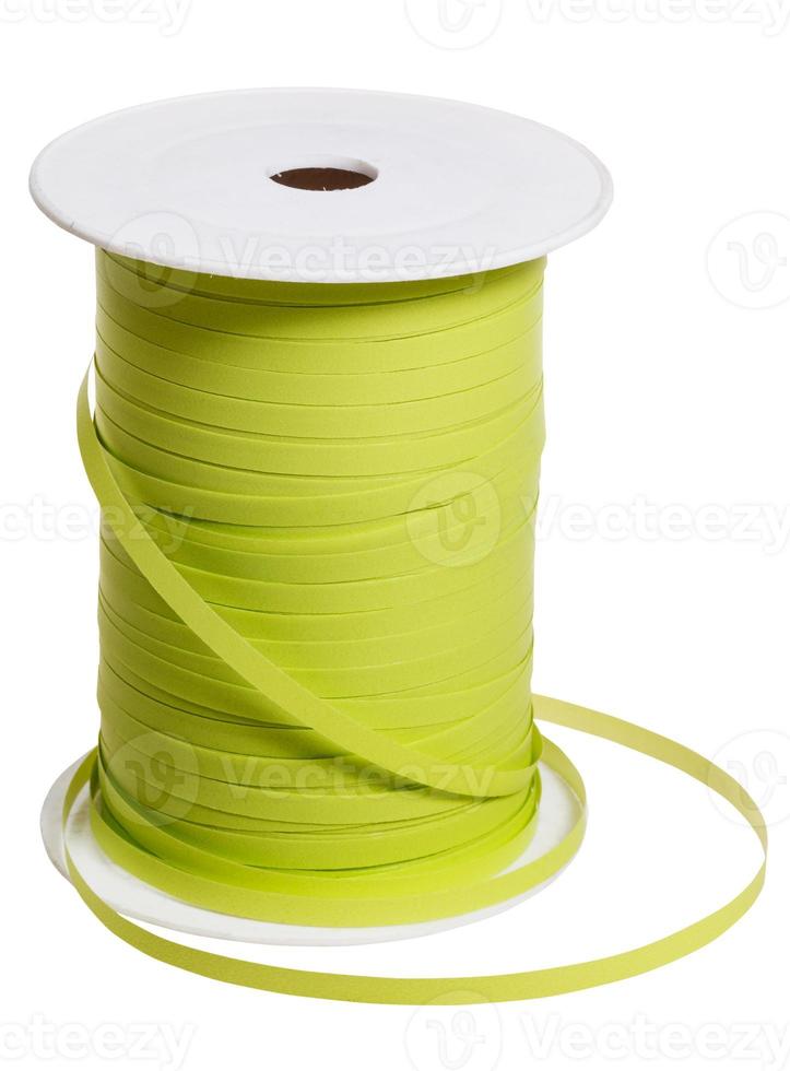 plastic reel with green packing tape isolated photo