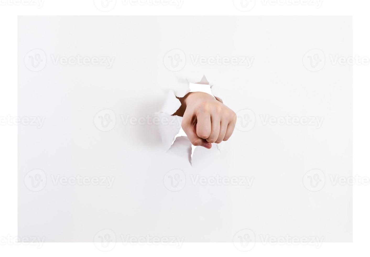 front view of the fist breaks a paper isolated photo