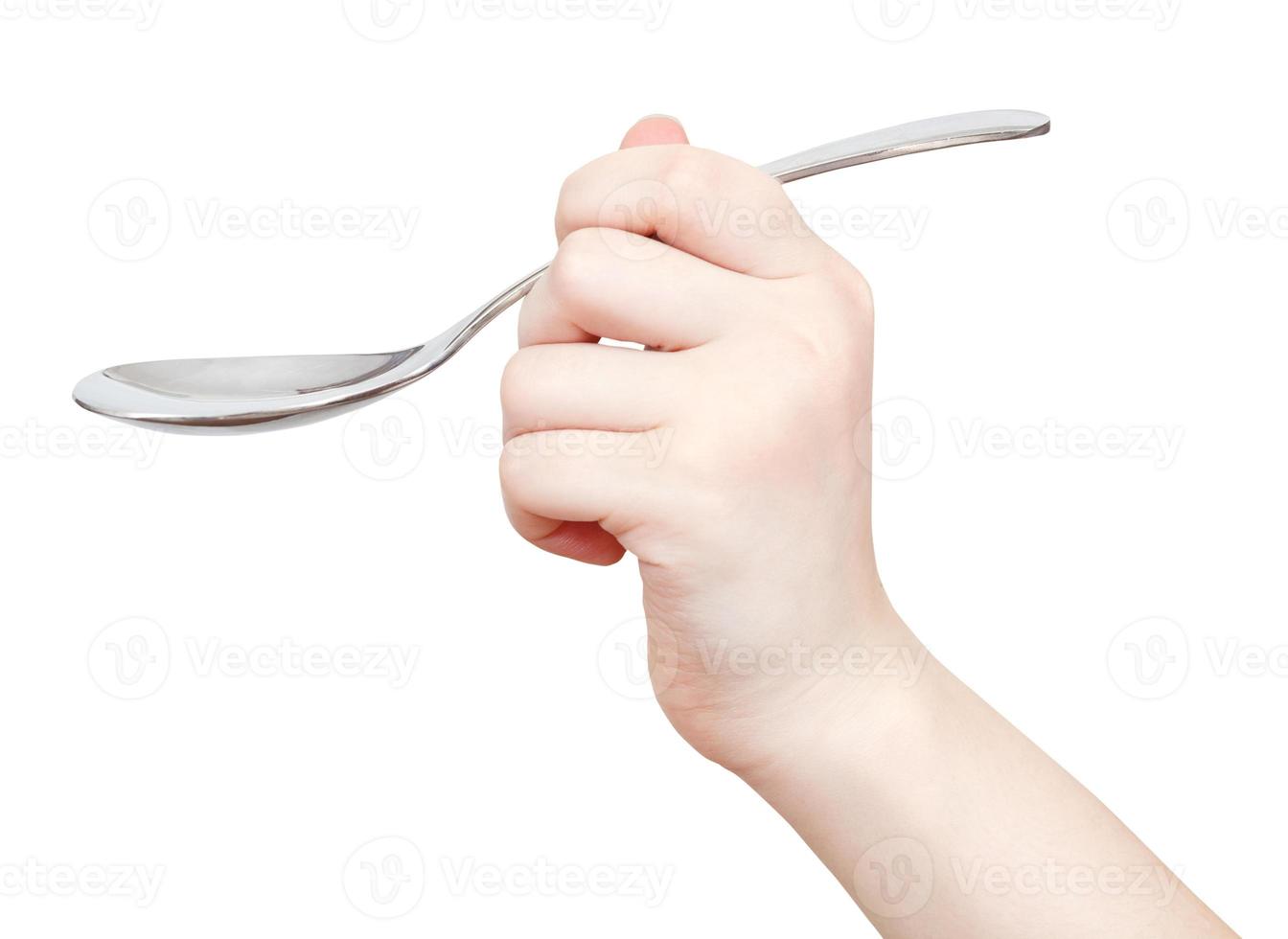 hand with tablespoon isolated on white photo