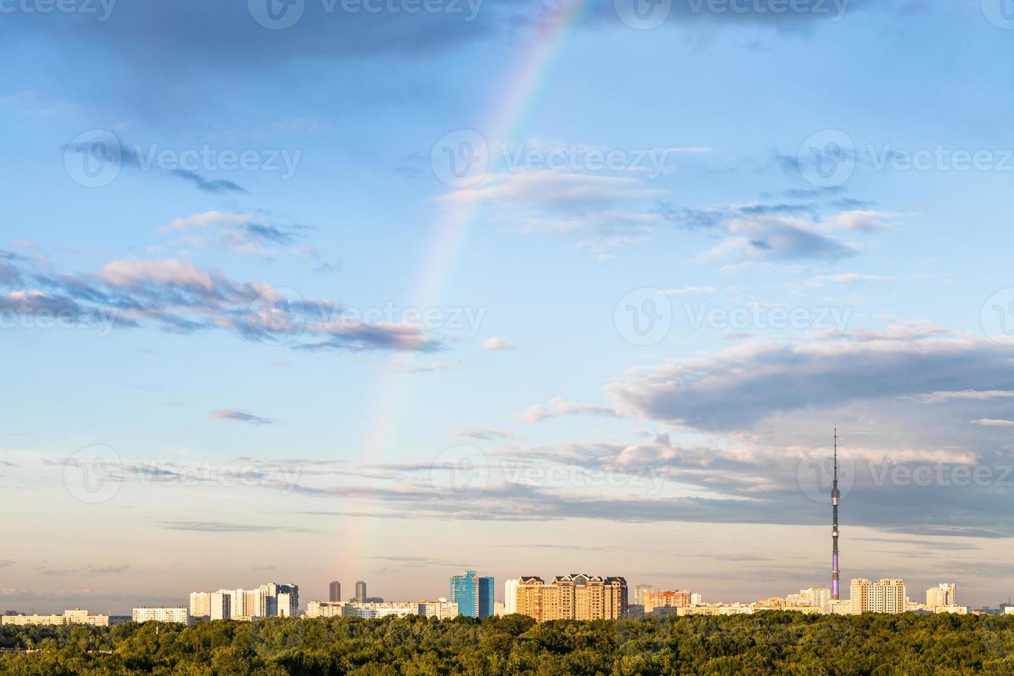 rainbow in evening sky over residential district photo