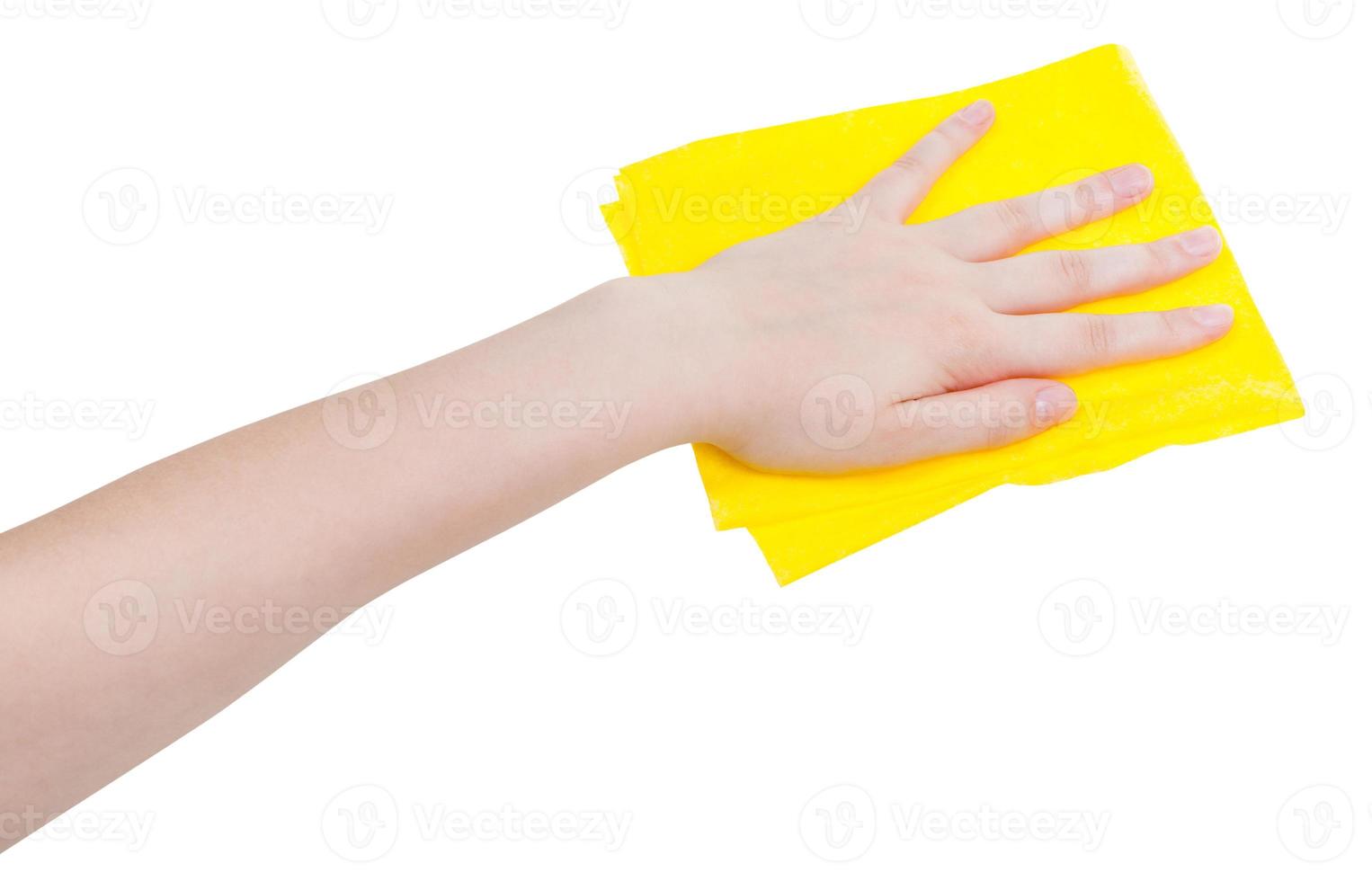 hand with yellow wiping rag isolated on white photo