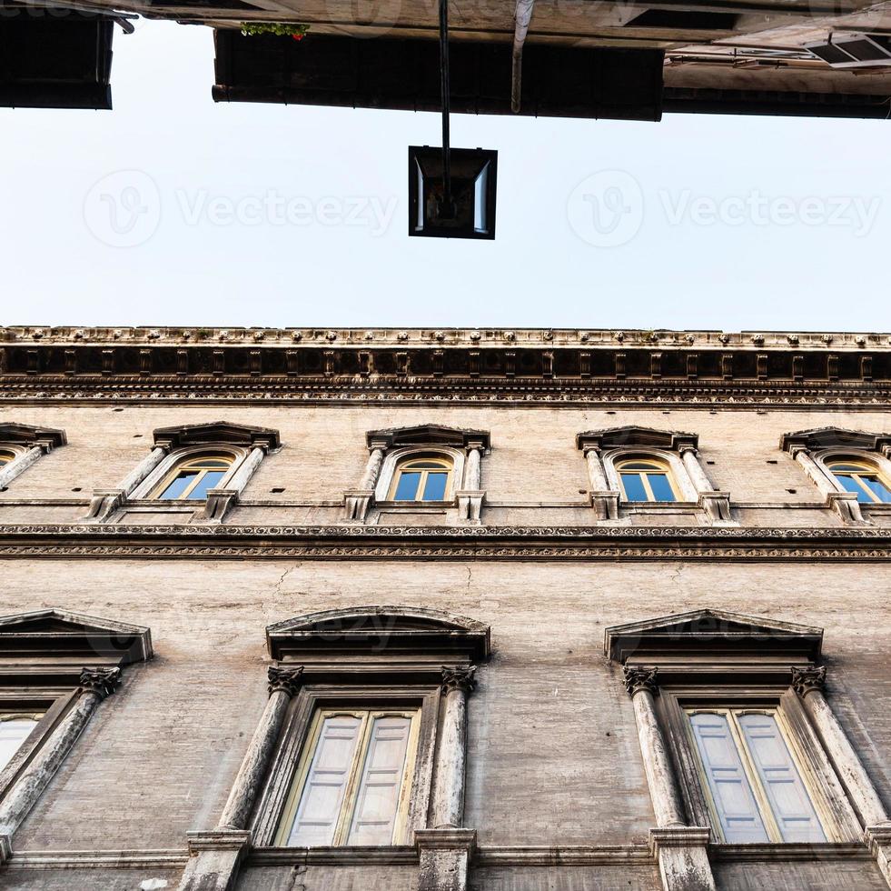 acades of palaces on narrow street in Rome photo