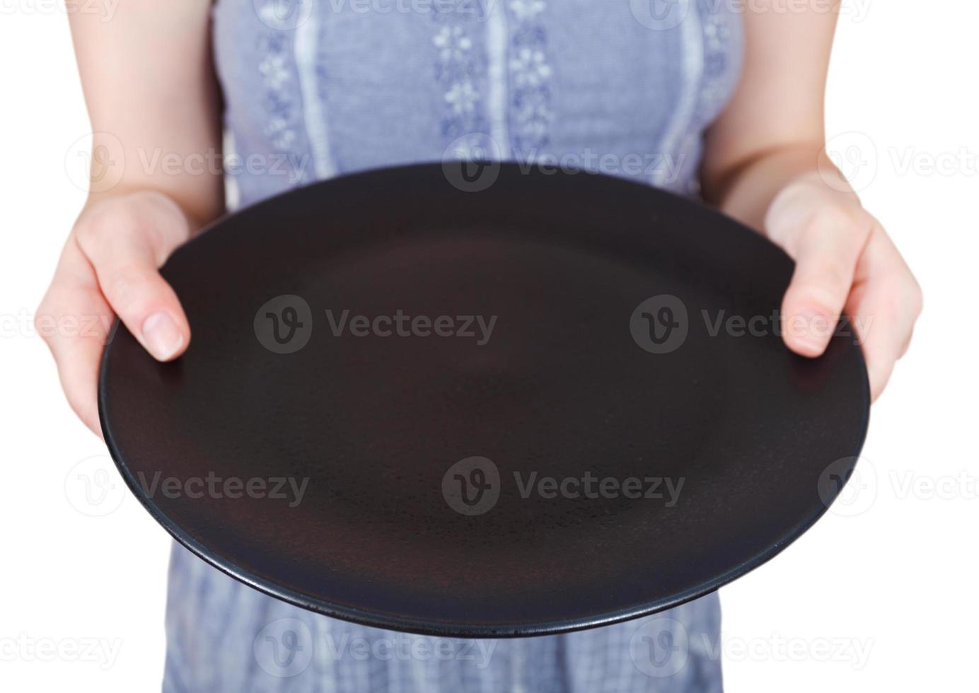 woman holds empty black plate photo