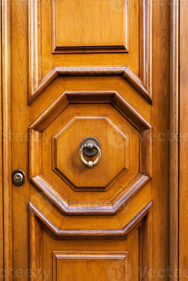 wood door with brass ring door knocker in Rome photo