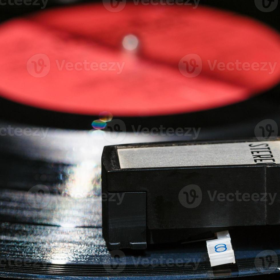 headshell on vinyl record in old turntable photo