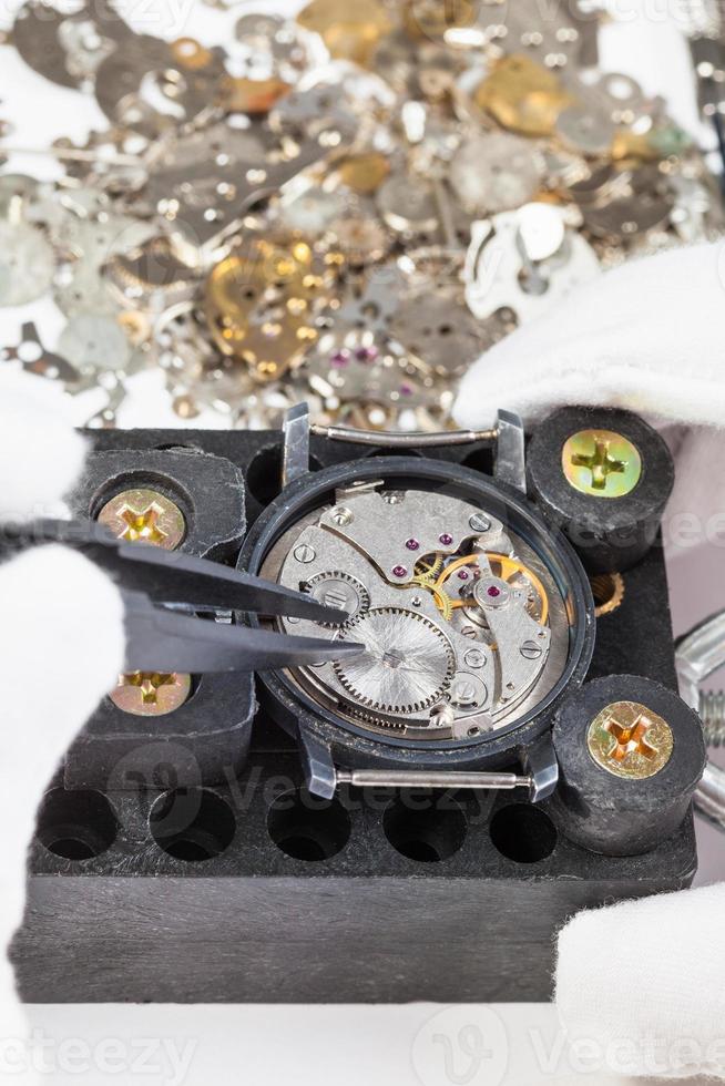 repairing of mechanical watch with spare parts photo