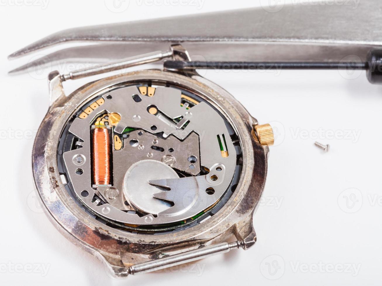 tools and replacing battery in watch close up photo