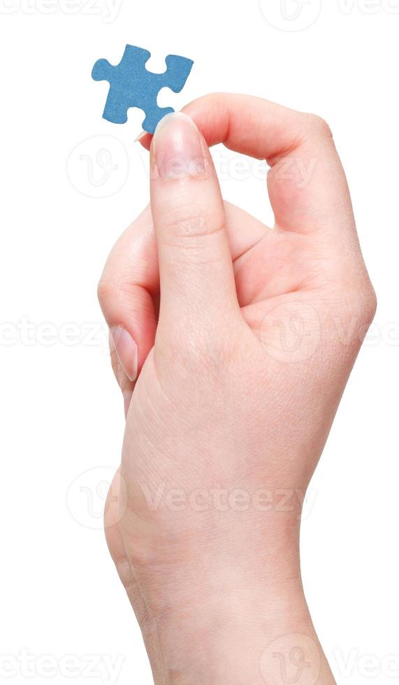 female arm keeps jigsaw puzzle piece photo