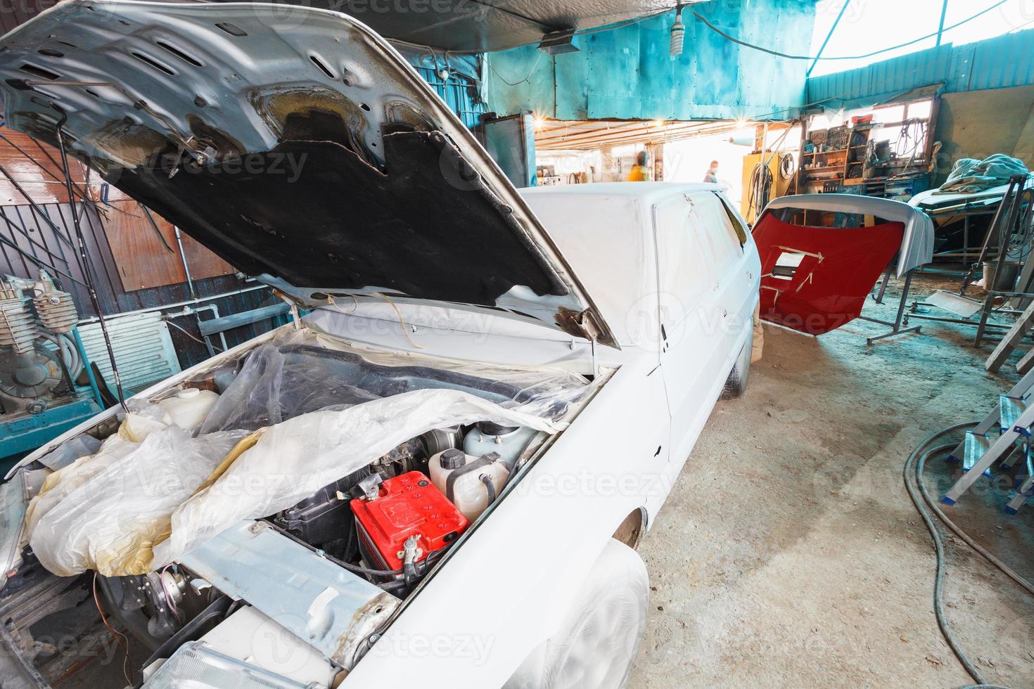 painting of old car in country garage photo