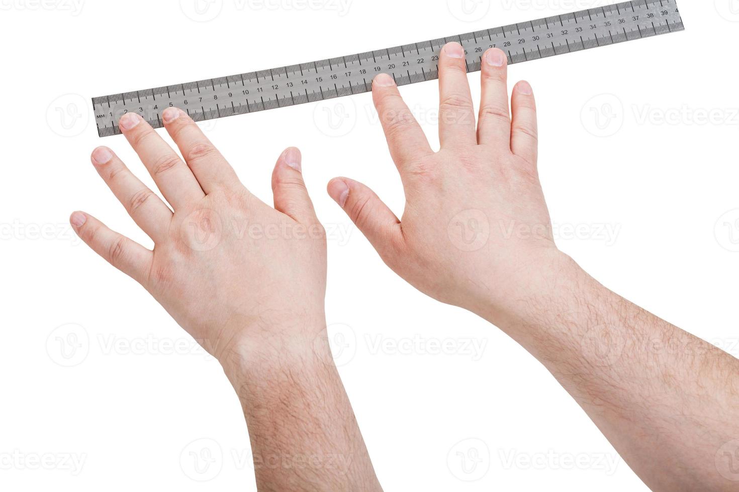 manos masculinas con regla de medición aislada foto