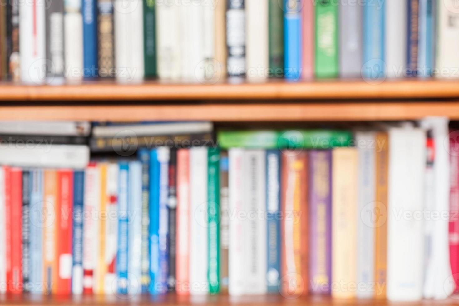 defocused background from books on bookshelf photo