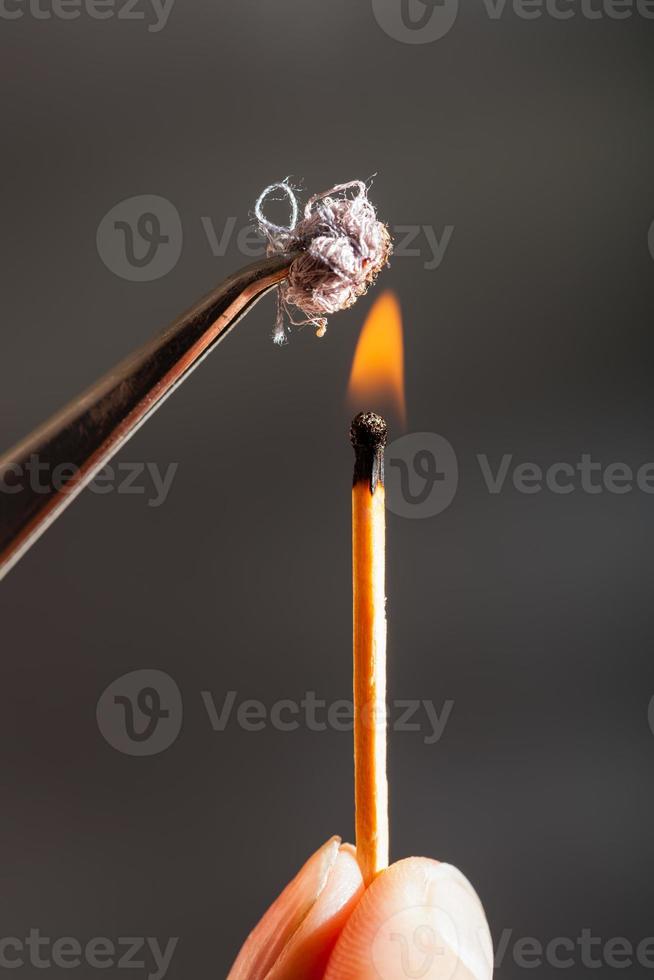 match flame ignites cotton tissue sample photo