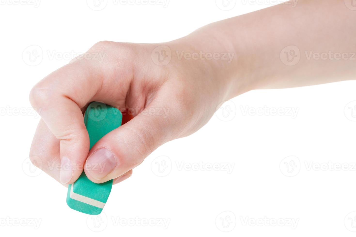 hand with green new rubber eraser close up photo