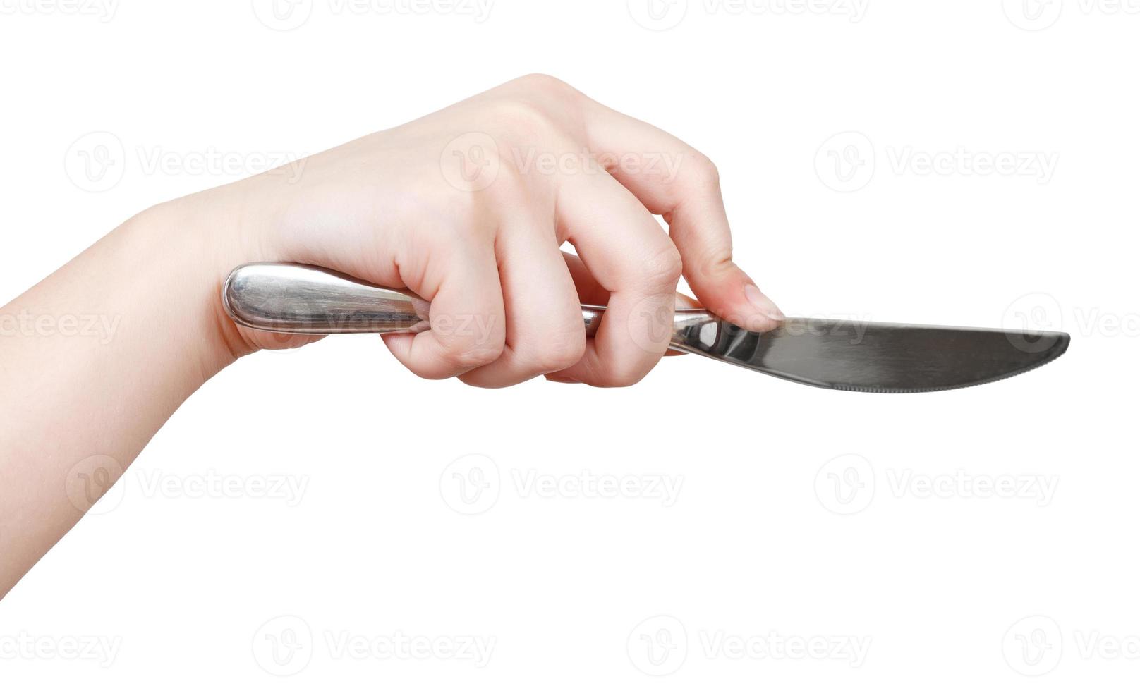 hand with table knife isolated on white photo