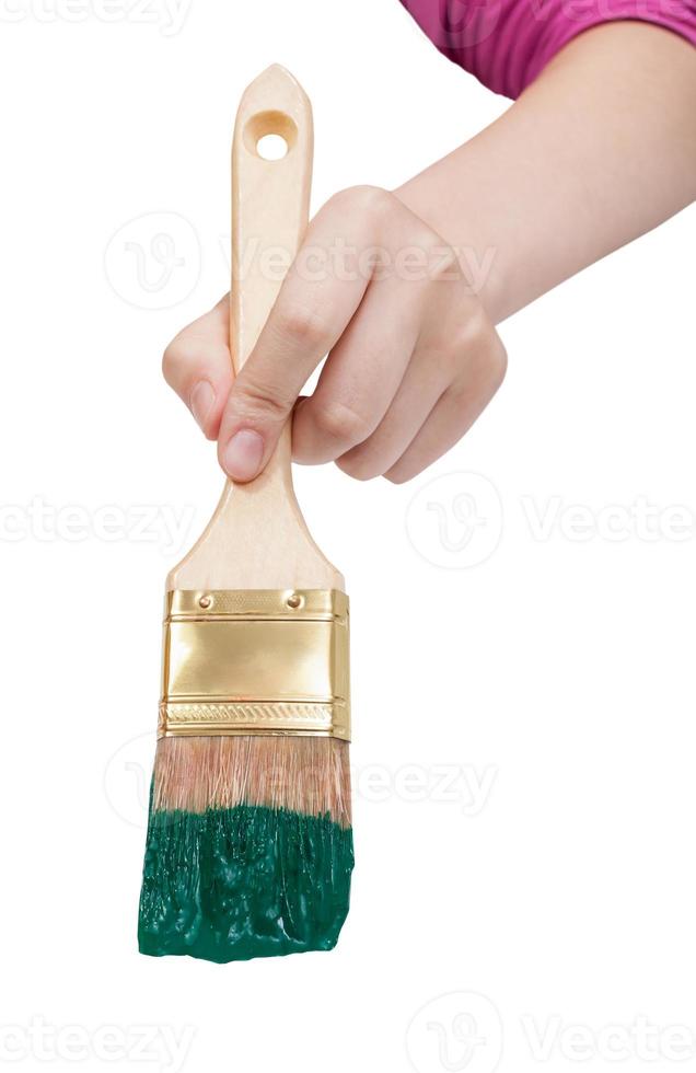 direct view of painter hand with green paintbrush photo