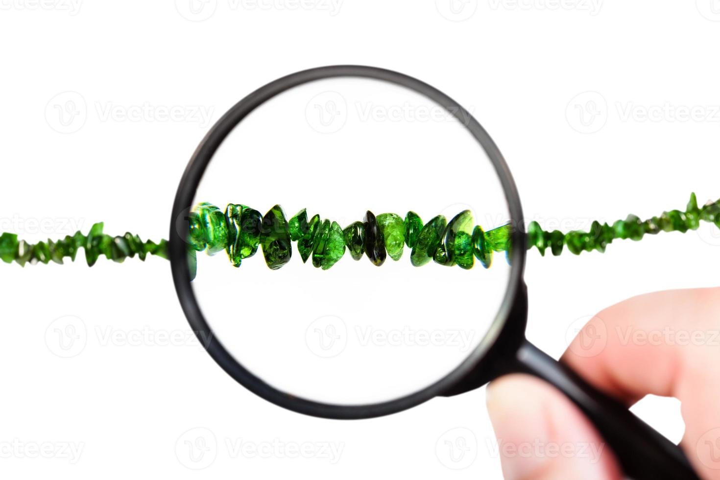 view of chrome diopside necklace through magnifier photo