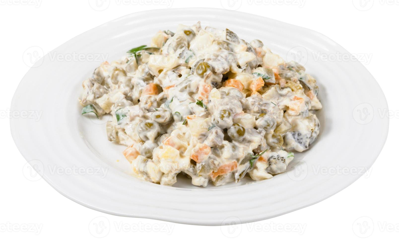 russian salad with mayonnaise on plate isolated photo