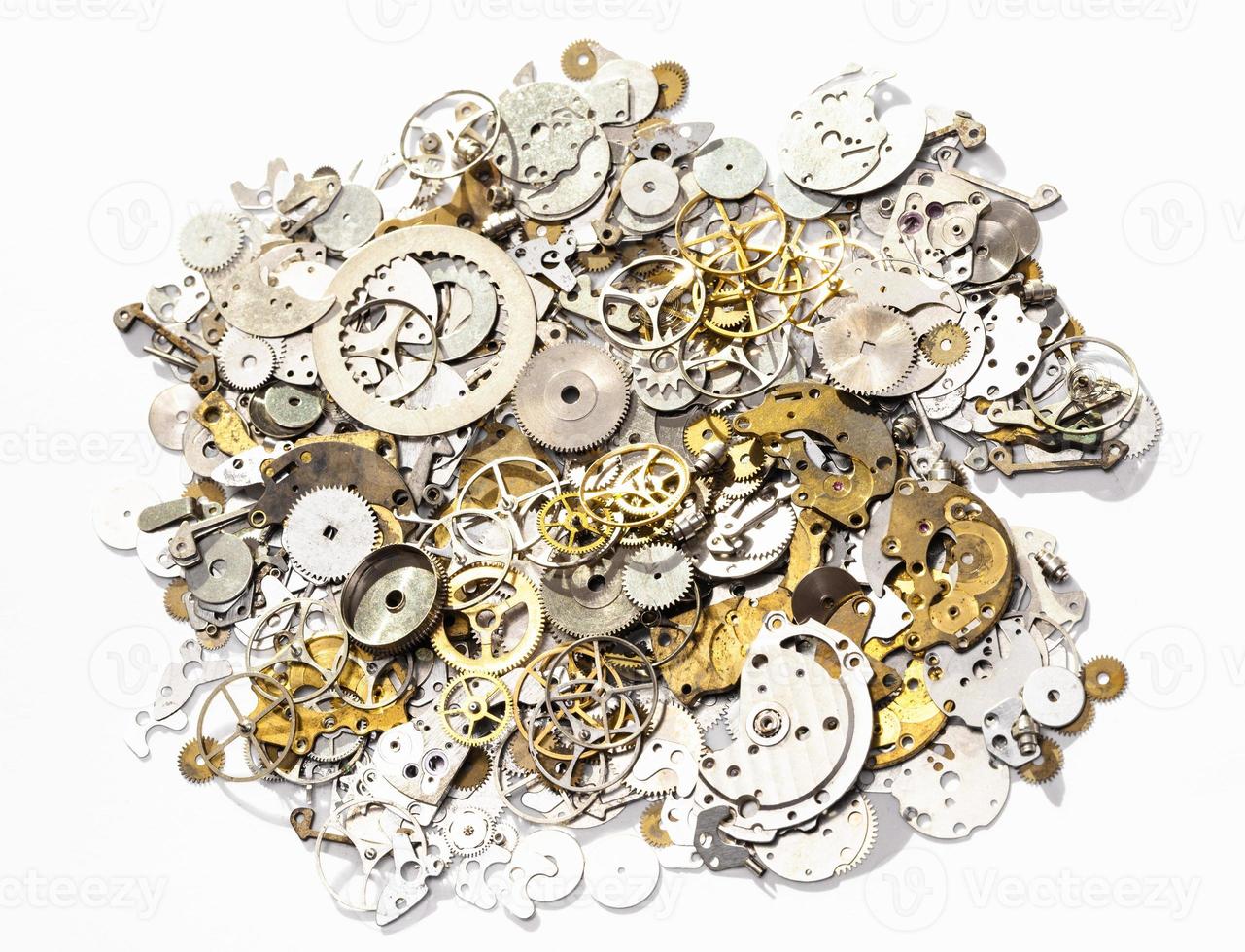 heap of used watch spare parts on white background photo