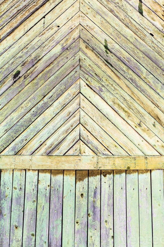 shabby green painted planks on wall of wood house photo