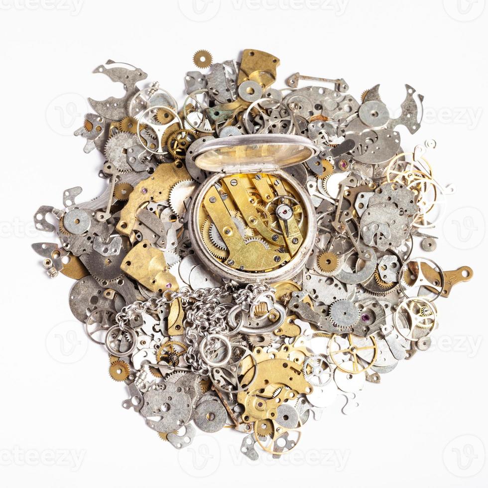 top view of pocket watch on heap of spare parts photo