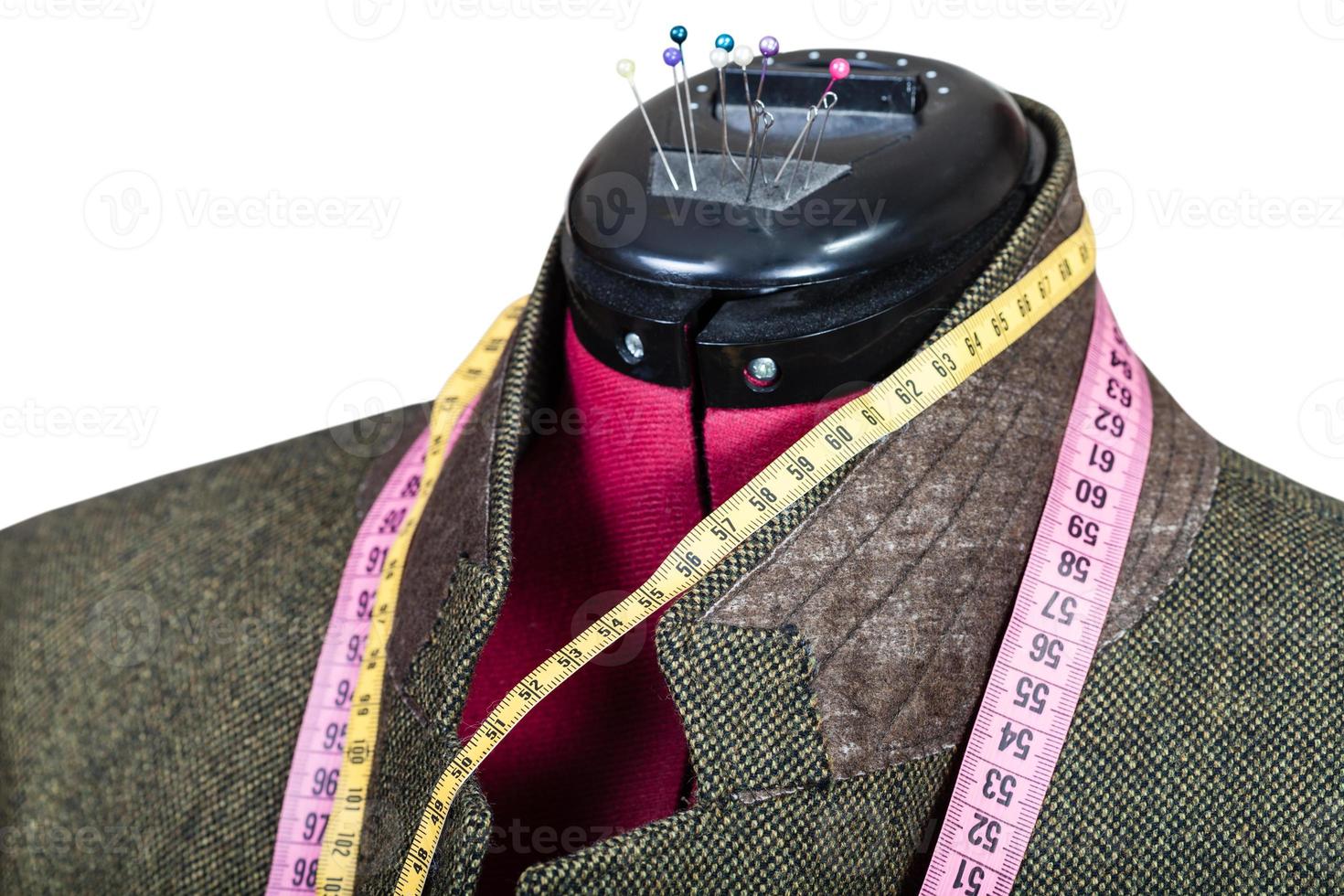 tailoring of male green tweed jacket on mannequin photo