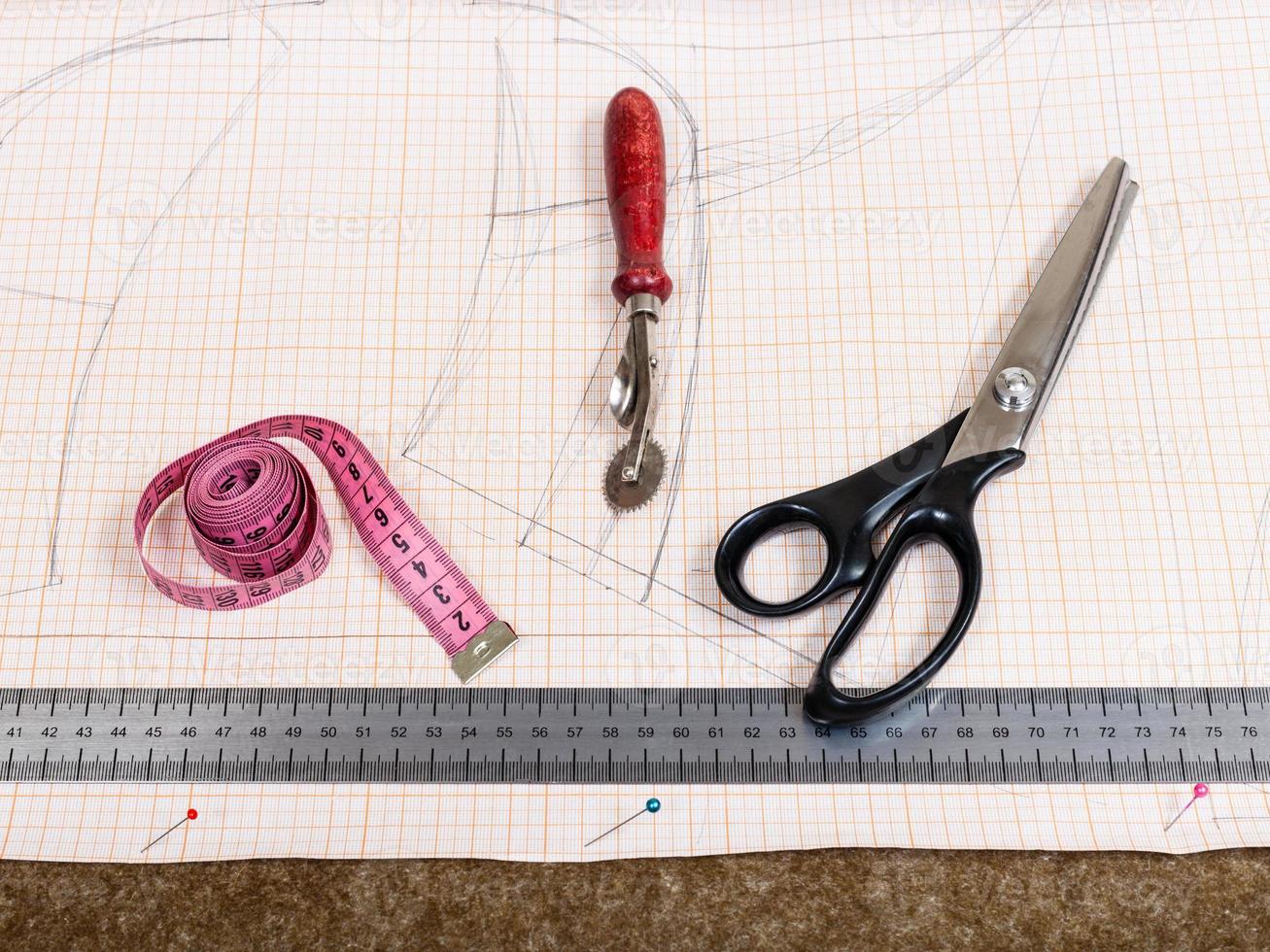 cutting table with textile, pattern, tailor tools photo