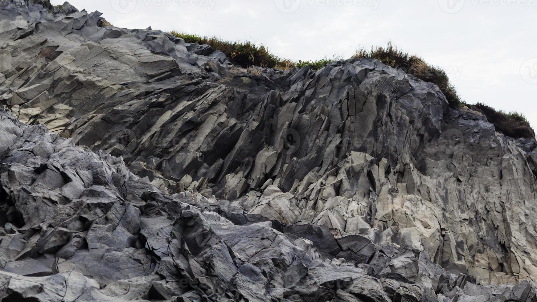 volcanic slope of Reynisfjall mount in Iceland photo