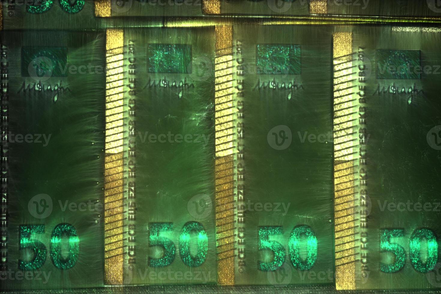Illustration of glowing euro banknotes with a green kirlian aura around them. photo