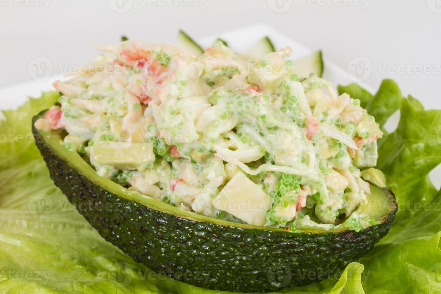 Crab meat salad with green caviar in avocado - japan cusine photo