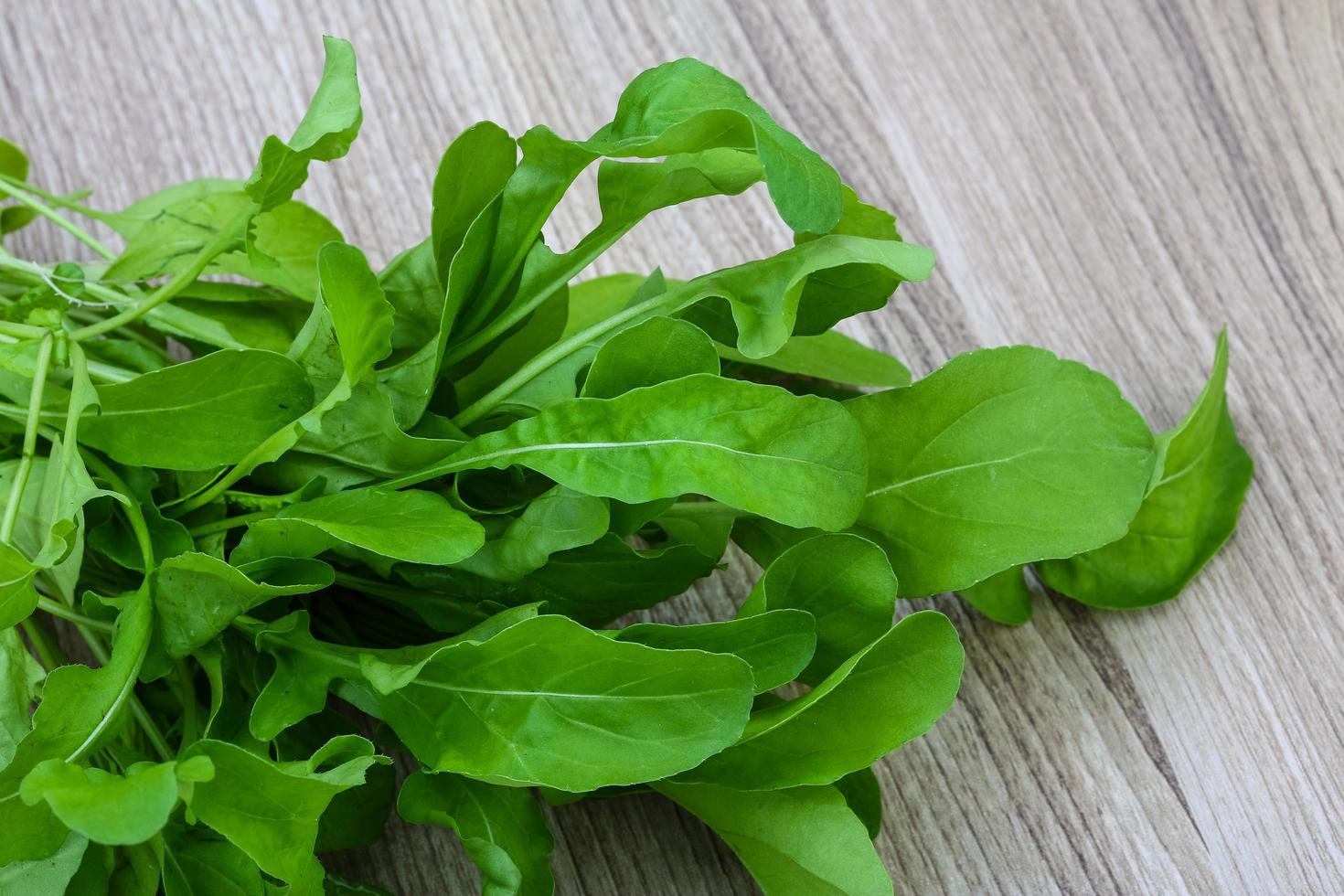 Ruccola on wooden background photo