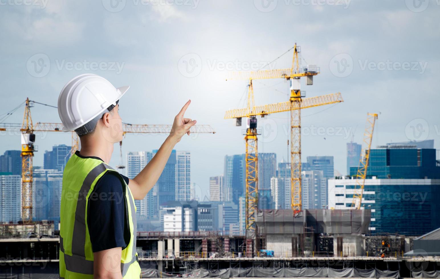 Asian civil engineer or architecture,professional worker man wearing white hat,young adult man working at construction site ,Concept work in success. photo