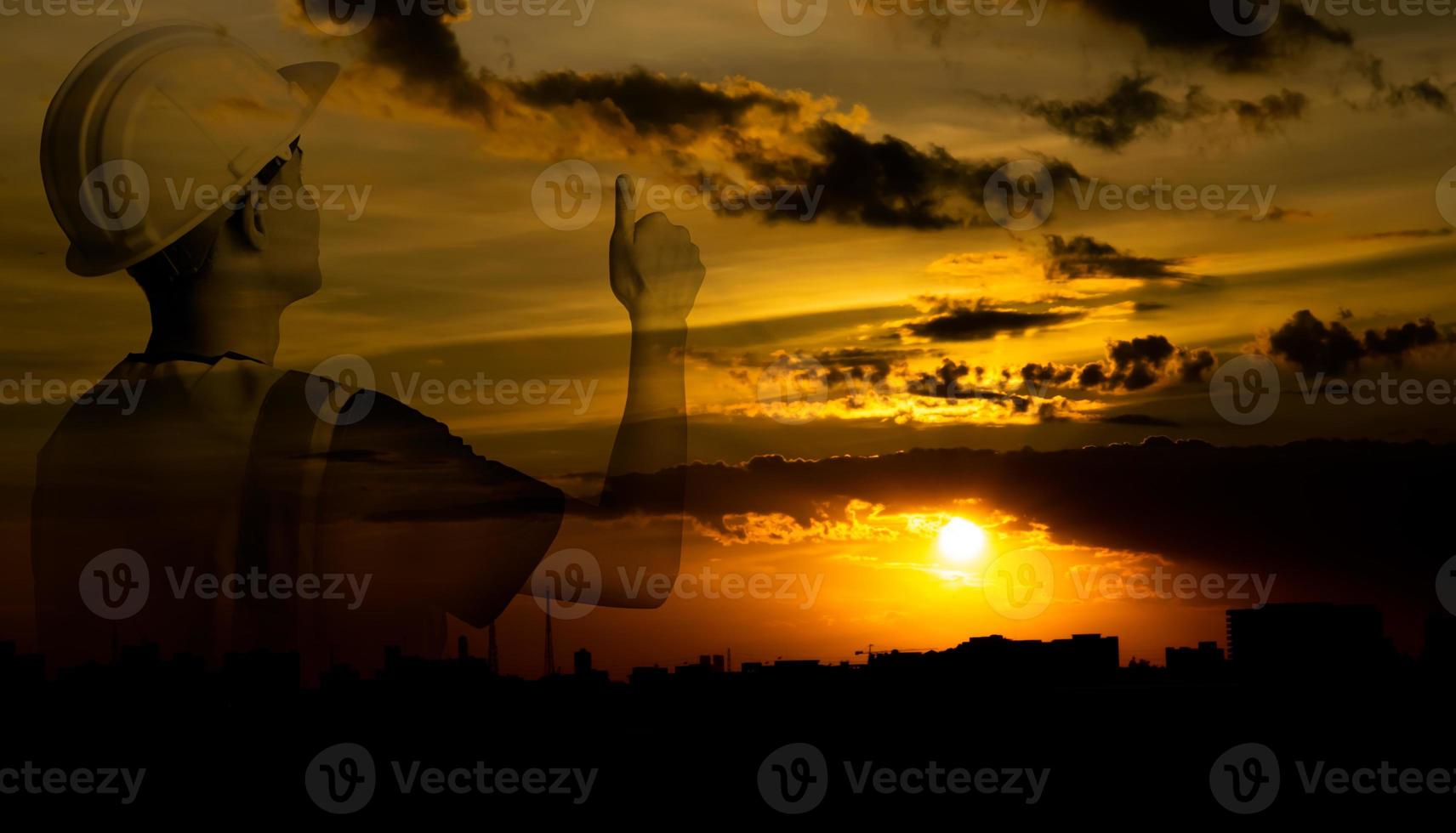 Silhouette double exposure image of architecture or civil engineer with orange sky sunset,builder wearing helmet,construction industry expand and grow,concept work in success. photo
