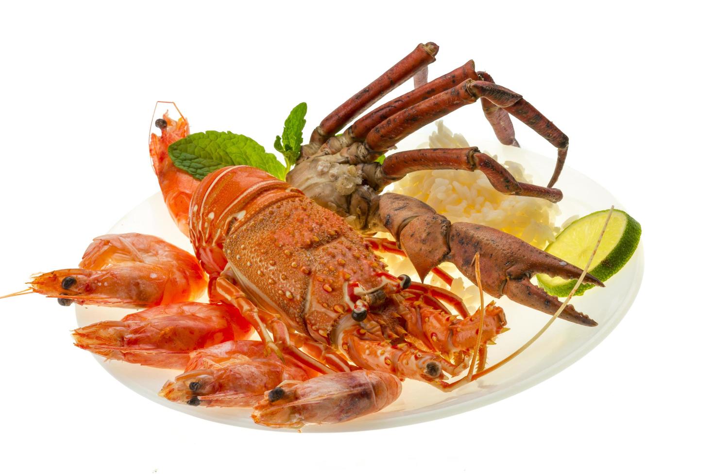 Spiny lobster, shrimps, crab legs  and rice photo